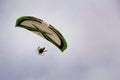Motorized paraglider flying through the sky