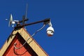 Motorized security camera with wireless transmission dish installed on christian mortuary chapel roof.