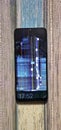 Motorola smartphone with broken screen  -  color and image distorsion Royalty Free Stock Photo