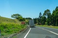 A motorway in the north of Australia driving trucks and at the edge there are signs with the inscription Reduce speed