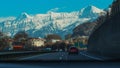 Motorway in switzerland with visibile some traffic and majestic mountains in the background Royalty Free Stock Photo