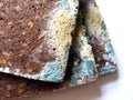 Mouldy bread close up on white background