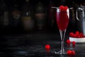 Raspberry Rossini alcoholic cocktail drink with prosecco, cava, or sparkling wine with raspberry puree and ice, dark bar counter