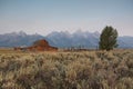 Moulton Barn with Hazy Grand Teton Mountains in the Background Royalty Free Stock Photo