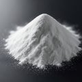 A mound of fine white powder sits against a dark background, forming a cone shape. Royalty Free Stock Photo