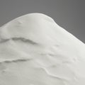 A mound of fine, white sand or powder with a smooth, undulating surface. It is against Royalty Free Stock Photo