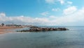 Mound of large stones on the beach. Cobblestones on the sandy shore of the Black Sea in the Crimea.