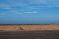 A mound of red sand on a blue sky background Royalty Free Stock Photo