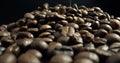 Mound of roasted coffee beans. Coffee product on black background.