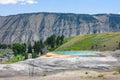 Mound Spring next to Liberty Cap in Mammoth Hot Springs area, Yellowstone Park. Town view. Royalty Free Stock Photo