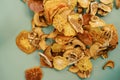 Mound of thin slices of dried fruits on a green background