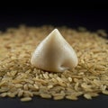 A mound of uncooked brown rice grains forms the base, with a single mound of white Royalty Free Stock Photo
