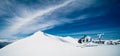 Mount Aspiring, New Zealand, October 6, 2019: Stunning panorama of a helicopter waiting to take off on top of the snowy mountain