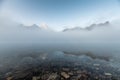 Mount Assiniboine in blue foggy reflection on lake Magog in the morning at provincial park Royalty Free Stock Photo