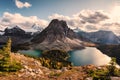 Mount Assiniboine with Sunburst and Cerulean lake in autumn pine forest Royalty Free Stock Photo