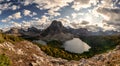 Mount Assiniboine with Sunburst and Cerulean lake in autumn pine forest at British Columbia Royalty Free Stock Photo