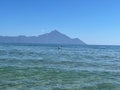 View from the beach in Sarti, with crystal clear, blue water and Mount Athos in the background