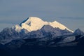 Mount Baker stands white against surrounding peaks in shadows in Washington State Royalty Free Stock Photo
