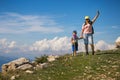 Mount Baldo, Italy - August 15, 2017: Happy mother with her son atop a hill in San Marino.