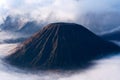 Mount Bromo, an active volcano surrounded by white clouds of mist. Royalty Free Stock Photo