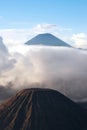 Mount Bromo, an active volcano surrounded by white clouds of mist in the morning at the Tengger Semeru National Park. Royalty Free Stock Photo