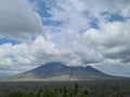 Mount Bromo view from far away with white clouds over the blue sky