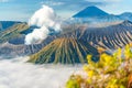 Mount Bromo volcano erupts with smoke and ash over a sea of clouds Royalty Free Stock Photo