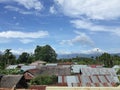 Mount Bukit Barisan, the setting of housing in the village and the beautiful blue sky and beautiful white clouds