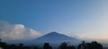 Mount Ciremai, the highest mountain in West Java, Indonesia, at dusk with beautiful white clouds and blue sky Royalty Free Stock Photo