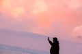 Mount Elbrus, Russia, Man takes a picture on the phone in the mountains during sunset