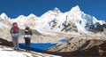 mount Everest and Nuptse from Nepal side as seen from Kala Patthar peak and two tourists with big backpacks Royalty Free Stock Photo