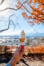 Mount Fuji and hand holding soft cream ice cream with autumn tree background Royalty Free Stock Photo