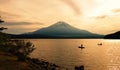 Recreational anglers silhouette fishing in front of Mount Fuji at dusk Royalty Free Stock Photo