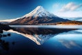 Mount Fuji reflected in Lake Kawaguchiko, Yamanashi, Japan, Volcanic mountain in morning light reflected in calm waters of lake,