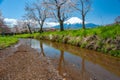 Mount Fuji, sakura trees and streams During the day with a clear sky in a rural area in Yamanashi prefecture