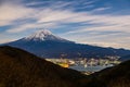 Mount Fuji, or Fuji San in Japanese, famous mountain in Japan standing tall against cloudy blue sky at night towering the Royalty Free Stock Photo