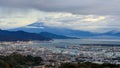 Mount Fuji and Shizuoka city with commercial cargo port foreground in the morning in japan, selective focus on fuji mountain