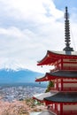 Mount Fuji viewed from behind Chureito Pagoda in full bloom cherry blossoms Royalty Free Stock Photo