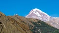 Mount Kazbek Mkinvartsveri and Gergeti church at sunny day. Caucasus mountains Royalty Free Stock Photo