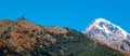 Mount Kazbek Mkinvartsveri and Gergeti church at sunny day. Caucasus mountains Royalty Free Stock Photo