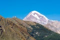 Mount Kazbek Mkinvartsveri and Gergeti church at sunny day. Caucasus mountains Royalty Free Stock Photo