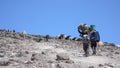 Mount Kilimanjaro / Tanzania: 5 January 2016: porters carry equipment and material to Barafu Camp on Mount Kiliimanjaro during a