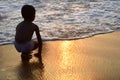 Mount Lavinia Beach. Colombo, Sri Lanka. 05th March 2016. Silhouette of Boy playing sand at the beach with the sunset background