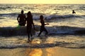Mount Lavinia Beach. Colombo, Sri Lanka. 05th March 2016. Silhouette of a family enjoying a bath at the beach with the sunset ba