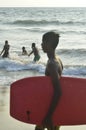 Mount Lavinia Beach. Colombo, Sri Lanka. 05th March 2016. Silhouette of a young surfer at the beach with the sunrise background