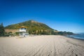 MOUNT MAUNGANUI, NEW ZEALAND - MARCH 6, 2020: The Surf Lifesaving tower stands ready on the Mount Main Beach on a beautiful sunny Royalty Free Stock Photo