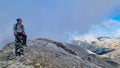 Mount Olympus - Man with helmet sitting on cloud covered mountain summit of Skolio peak on Mount Olympus Royalty Free Stock Photo