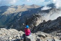 Mount Olympus - Rear view of woman with climbing helmet on cloud covered mountain summit of Mytikas Mount Olympus Royalty Free Stock Photo