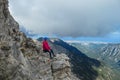 Mount Olympus - Rear view of woman with climbing helmet on cloud covered mountain summit of Mytikas Mount Olympus Royalty Free Stock Photo