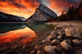 Mount Rainier, Canadian Rockies, Banff National Park, Alberta, Canada, Sunrise reflects on an orange mountain at Lake Minnewanka Royalty Free Stock Photo